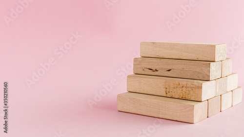 Fototapeta Naklejka Na Ścianę i Meble -  Wooden toy staircase on pink background for step to goal success concept