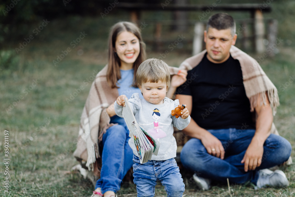 Fototapeta premium Happy family outdoors spending time together