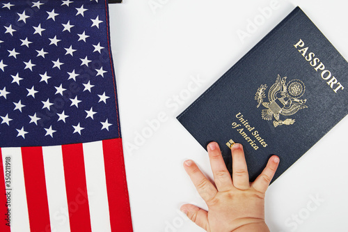 US passport. White background. The baby's hand reaching for it.