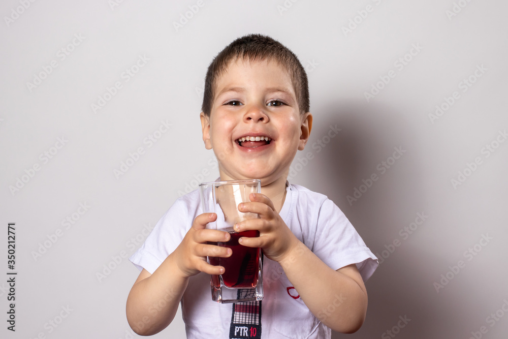 Little boy drinks cherry berry juice. Juices and vitamins for children, baby and drink. Little boy drinks cherry berry juice. Juices and vitamins for children, baby and drink.