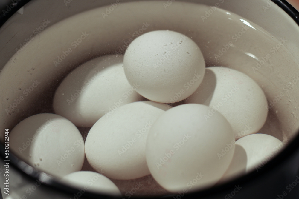 White eggs are boiled in water for Easter White eggs are boiled in water for Easter
