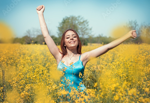 Happy woman in rapeseed field