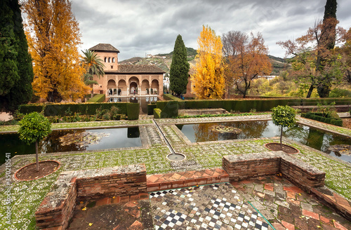 Park and pools around 14th century fortress complex of Alhambra, example of historical arabic architecture. Spain.  photo