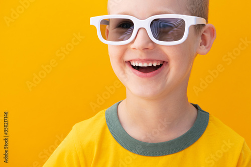 Cheerful baby boy with white 3d movie glasses © dimasobko