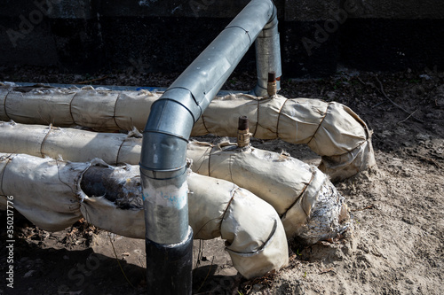 Wallpaper Mural Old rusty fiberglass insulated city water pipes. Wrapped pipes in glass wool street heating in winter Torontodigital.ca