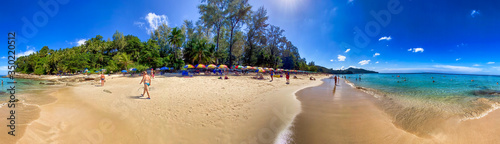 PHUKET, THAILAND - DECEMBER 19, 2019: Tourists enjoy the beautiful Surin Beach on a sunny day. Panoramic view