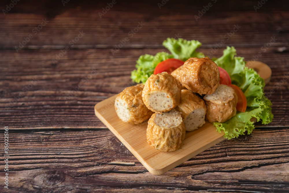 Deep fried chicken rolls as Chinese traditional food on wooden table for background 
