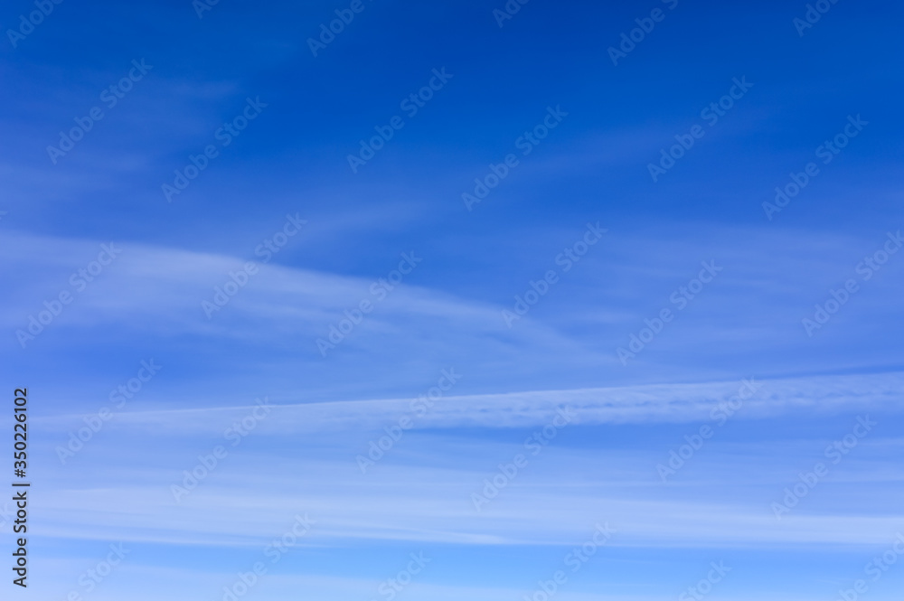 Light clouds in a clear blue sky abstract background