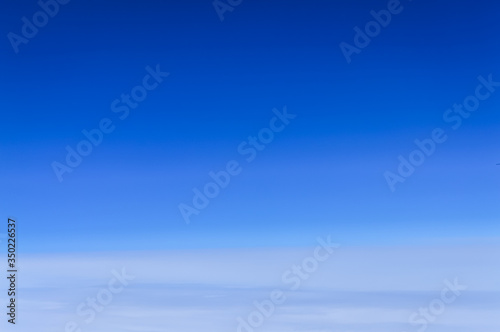 Light clouds in a clear blue sky abstract background