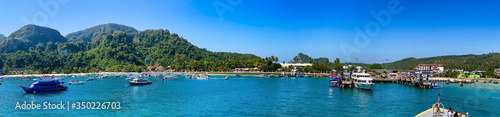 PHI PHI DON, THAILAND - DECEMBER 23, 2019: Tonsai Pier with boats on a beautiful morning. Panoramic view