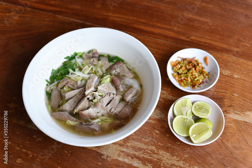 Top view Khanom Chin Nam Ngeaw, Rice noodles or Thai North East local noodle made from fermented rice flour with pork soup. Delicious local food for sell at Chiang Khan Thailand only. Selected focus