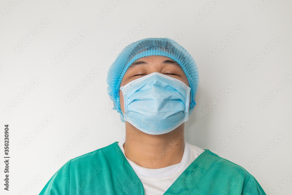 Close up portrait of Tired doctor at the hospital. A doctor, a nurse who is thinking about treating a disease and a pandemic. Surgeon after surgery. Coronavirus, covid-19 concept Close up portrait of Tired doctor at the hospital. A doctor, a nurse who is thinking about treating a disease and a pandemic. Surgeon after surgery. Coronavirus, covid-19 concept