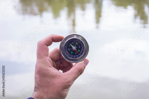 Compass on lake background