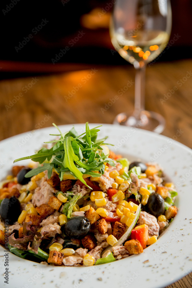 Fotografie Tun salad with olives, corn and rocket