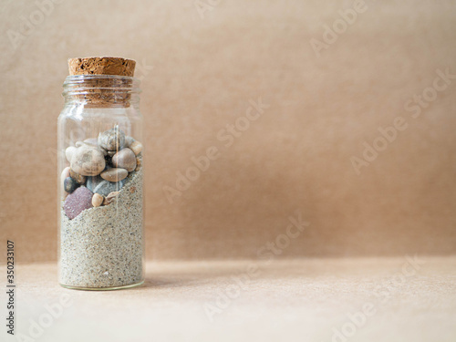 Jar with sand and beach stones photo