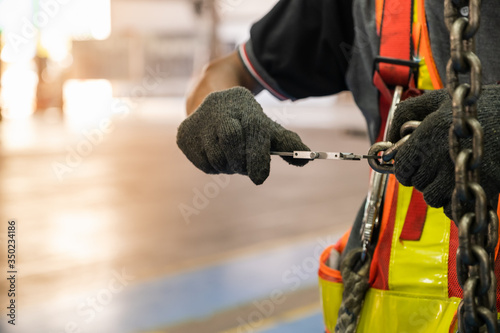 Engineers are inspecting hooks for lifting safety crane steel In the factory auto parts license Crane Operation