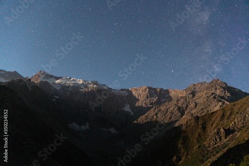 The Pamir range view and peaceful campsite on Kulikalon lake in Fann mountains in Tajikistan. The night time photo of stars and universe
