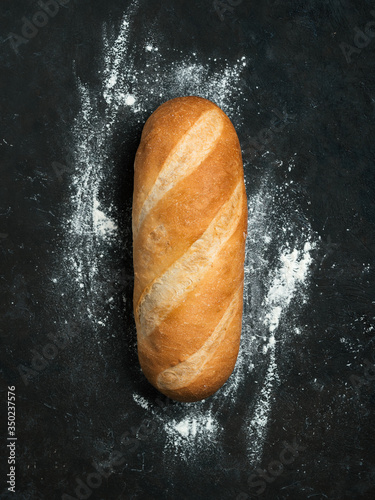 Obraz na plátně British White Bloomer or European Baton loaf bread on black background