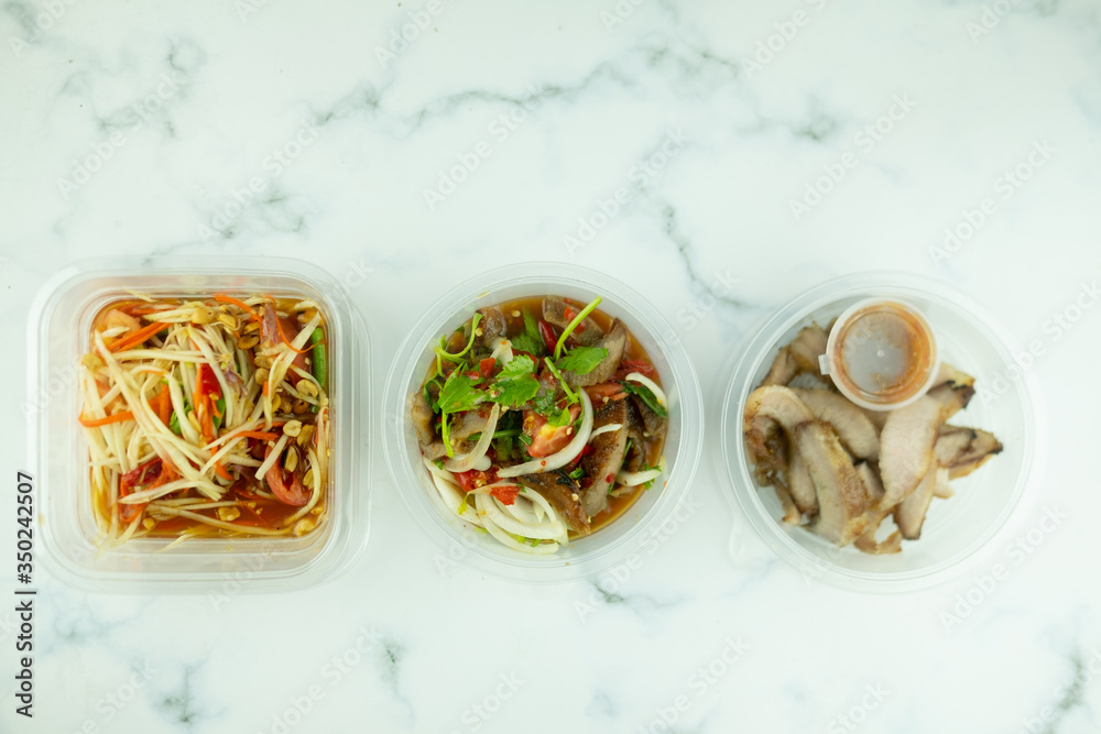 Thai local food such as papaya spicy salad, grilled pork and grilled pork spicy salad Thai local food such as papaya spicy salad, grilled pork and grilled pork spicy salad