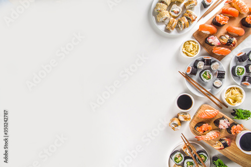 Japanese food. Big sushi set. Assorted set of various sashimi, maki and sushi rolls with different fillings - tuna, sea bass, salmon, shrimp, vegetables. Flatlay copy space