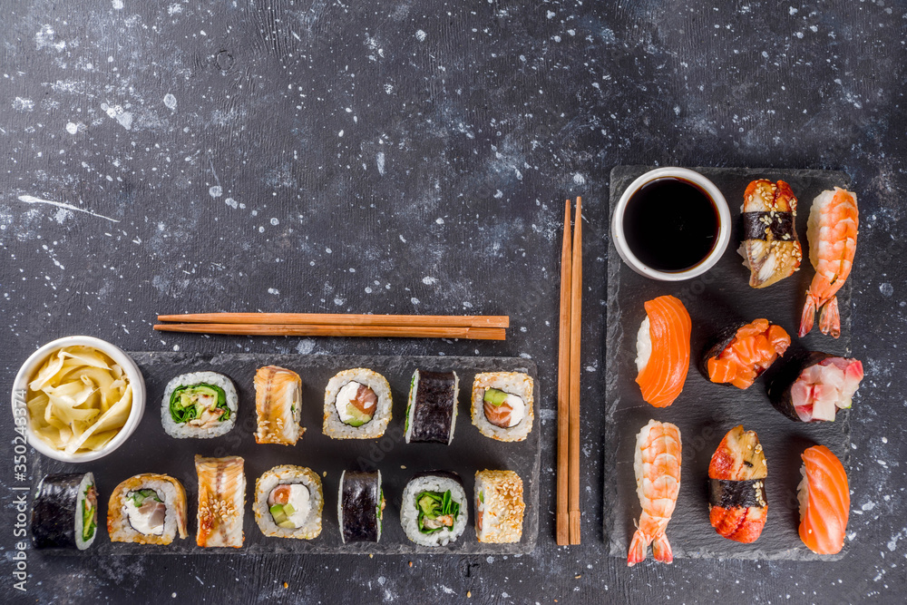 Japanese food. Big sushi set. Assorted set of various sashimi, maki and sushi rolls with different fillings - tuna, sea bass, salmon, shrimp, vegetables. Flatlay copy space Japanese food. Big sushi set. Assorted set of various sashimi, maki and sushi rolls with different fillings - tuna, sea bass, salmon, shrimp, vegetables. Flatlay copy space