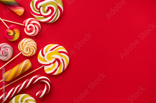 Sweet colorful lolly pops on red