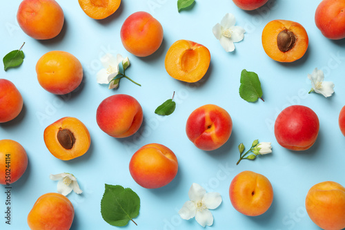 Fresh tasty apricots on blue background  top view