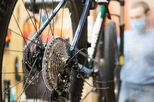 Bicycle repair shop, technical maintenance of a bike. Close-up view of a breaking system and transmission of a cross country bicycle in service shop