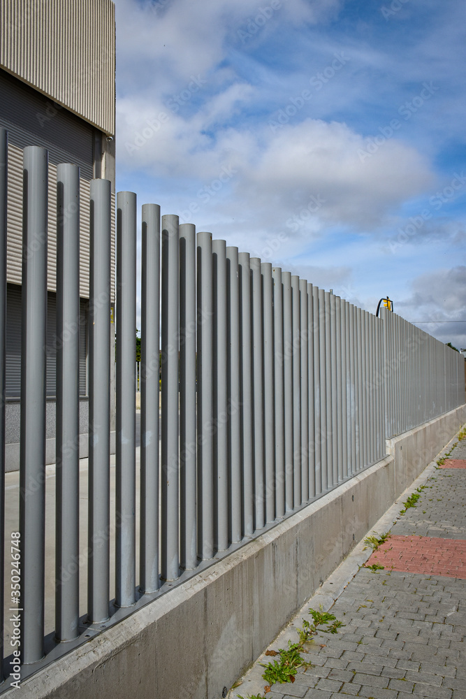 metal pipe fence and gray concrete