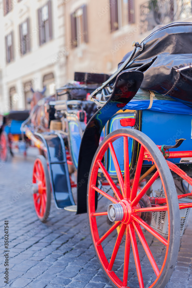 ROME, ITALY - 2014 AUGUST 17. Horse coach with big red wheels in the street of Rome.