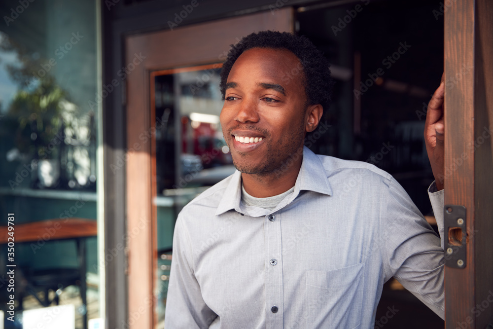 Fototapeta premium Male Owner Of Start Up Coffee Shop Or Restaurant Standing In Doorway