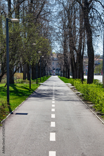 Vilnius. City center. Town square and park. City flag. Walking paths. Tracks for bicycles. Sunny spring day photo