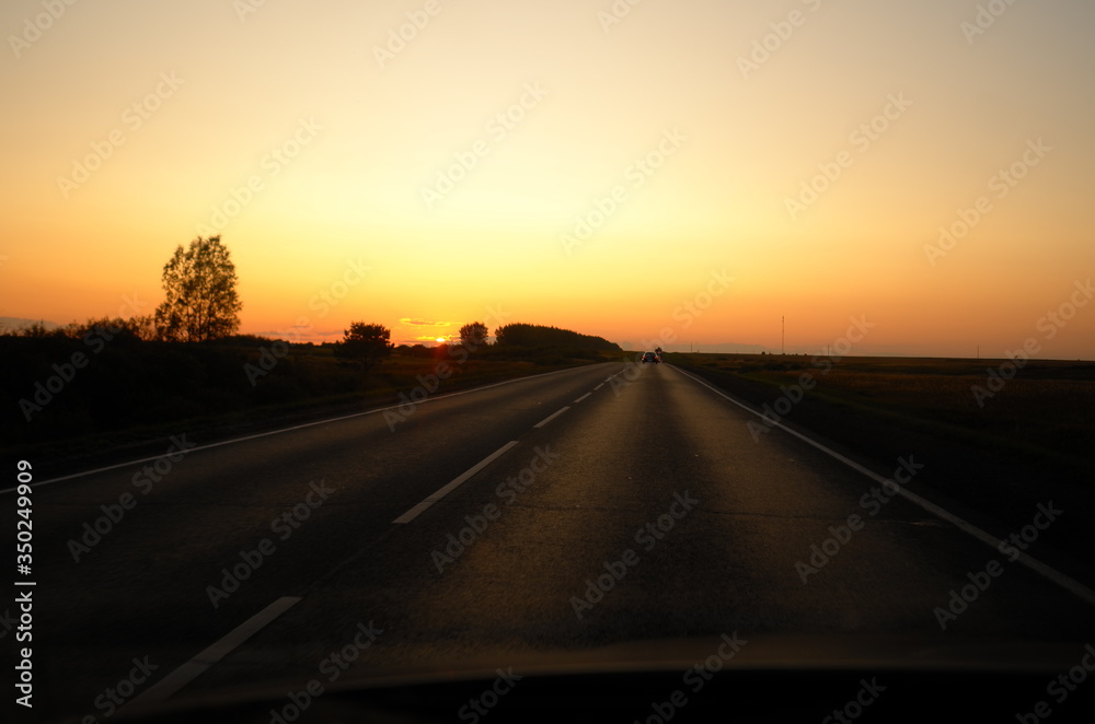 Sunset view from the car on the road