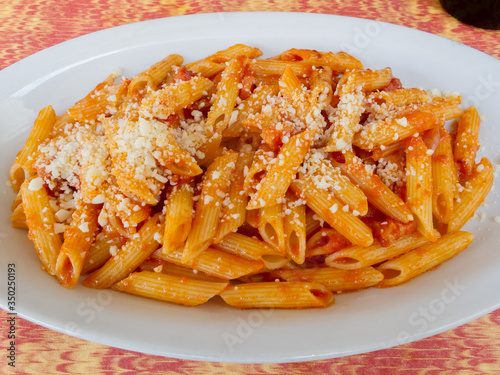 ROME, ITALY - 2014 AUGUST Pasta Penne with Tomato Bolognese Sauce and Parmesan. Italian cuisine.