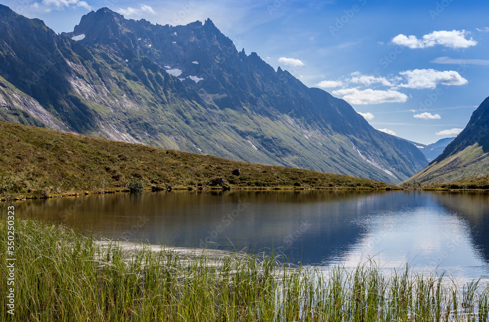 ROMEDALEN, NORWAY - 2014 JULY 21. Dreamy mountain valley with green forests, rocks and lake.