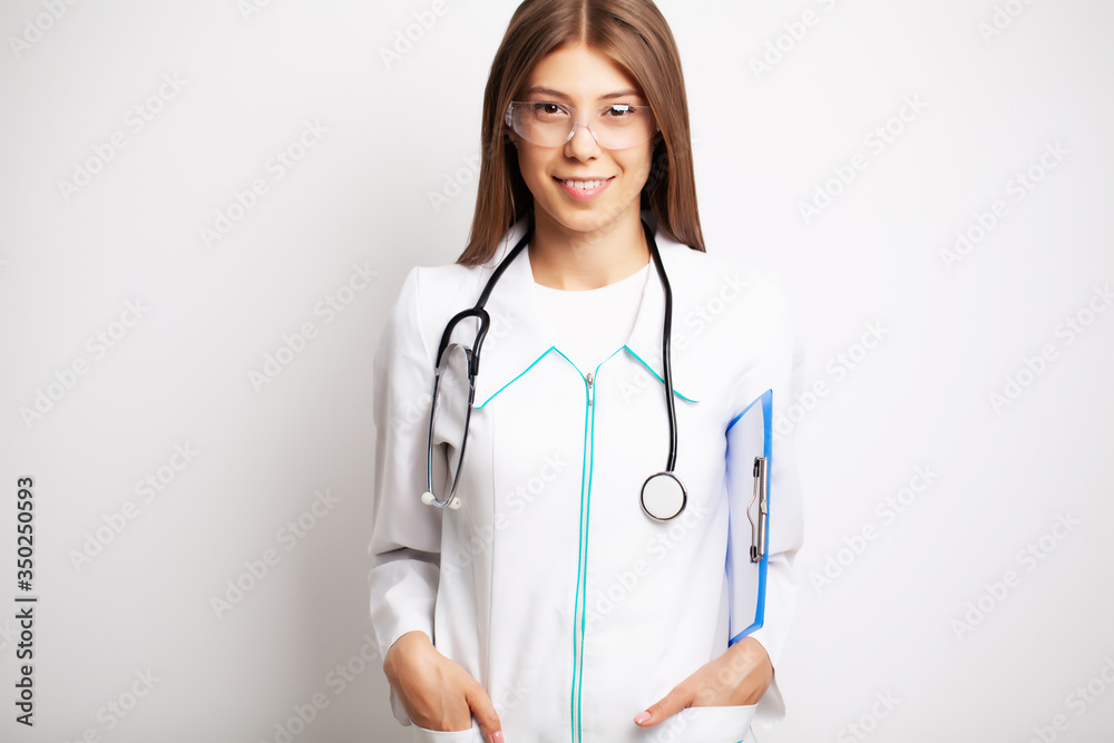 Doctor with protective goggles and stethoscope on her workspace Doctor with protective goggles and stethoscope on her workspace
