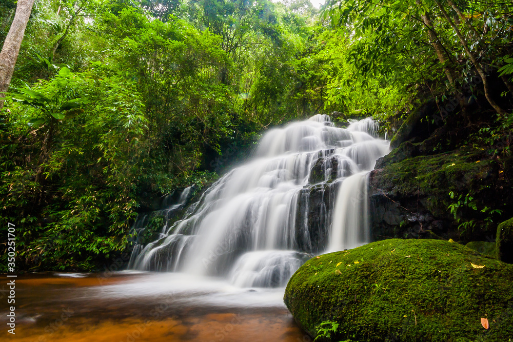 Beautiful nature rock waterfall steps. Waterfall in mountain valley with tropical rainforest at Mun Dang Waterfall, Phu Hin Rong Kla National Park, Phetchabun, Thailand.