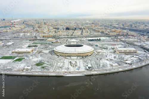 Aerial view of stadium and Moskva river. Moscow-city towers on the horizon. Beautiful spring sunrise over the city