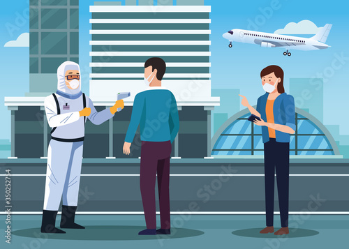 biosafety worker checking temperature in airport for covid19