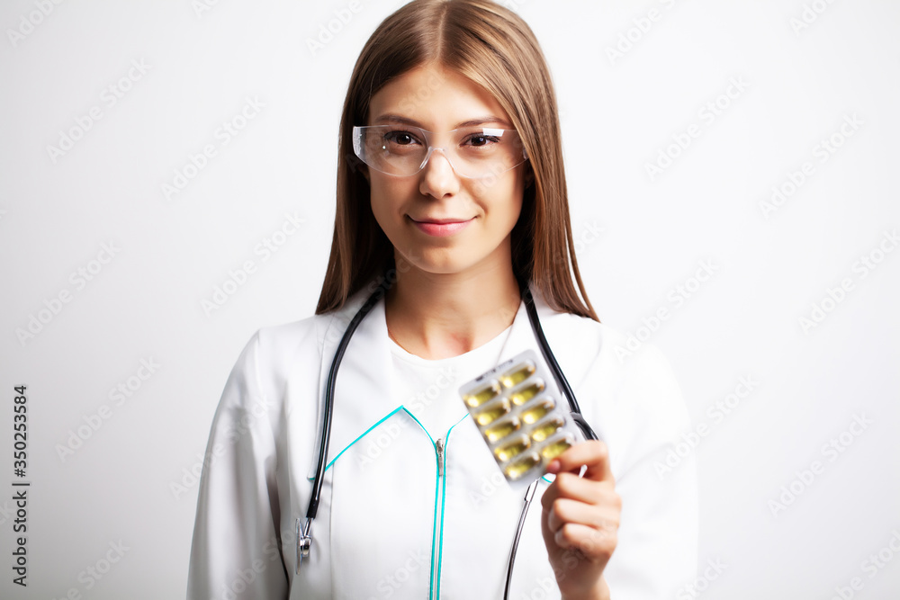 Doctor holds in his hands the prescribed pills for patient Doctor holds in his hands the prescribed pills for patient