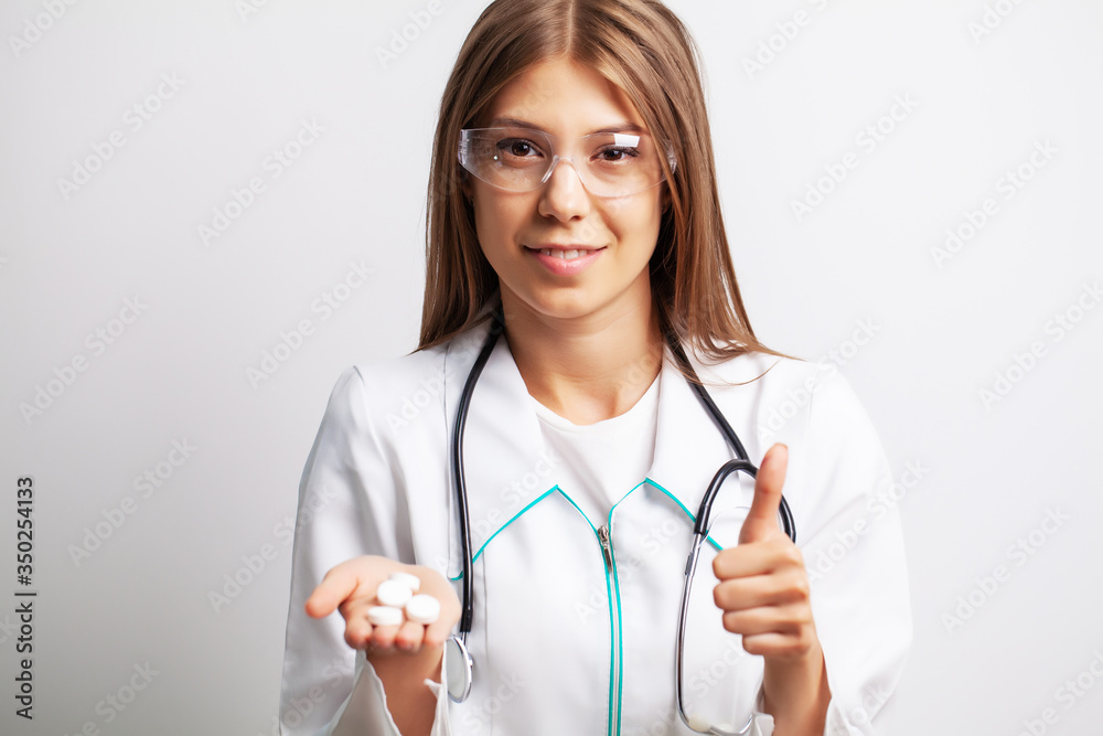 Doctor holds in his hands the prescribed pills for patient Doctor holds in his hands the prescribed pills for patient
