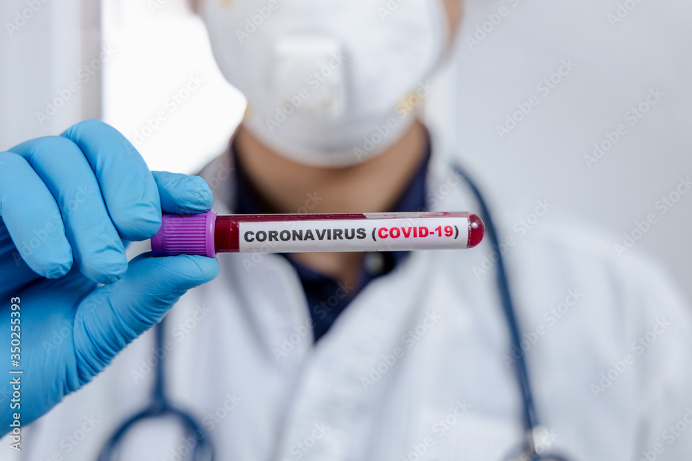 Coronavirus (COVID-19) testng concept, The doctor holds a test tube containing a blood sample. Coronavirus (COVID-19) testng concept, The doctor holds a test tube containing a blood sample.