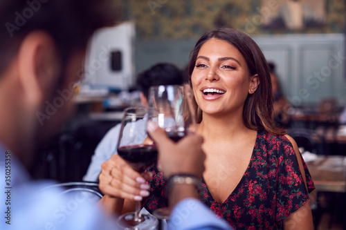 Couple On Valentines Day First Date Making A Toast In Restaurant