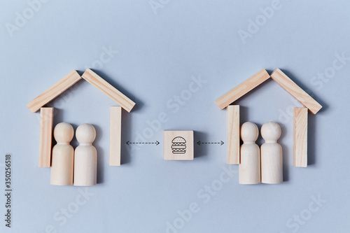 Food delivery. Remote food ordering. Delivery service concept. Wooden figure at home wait for delivery on blue backdrop