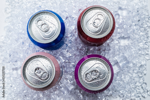 Group of aluminium cans in ice, cold drink.