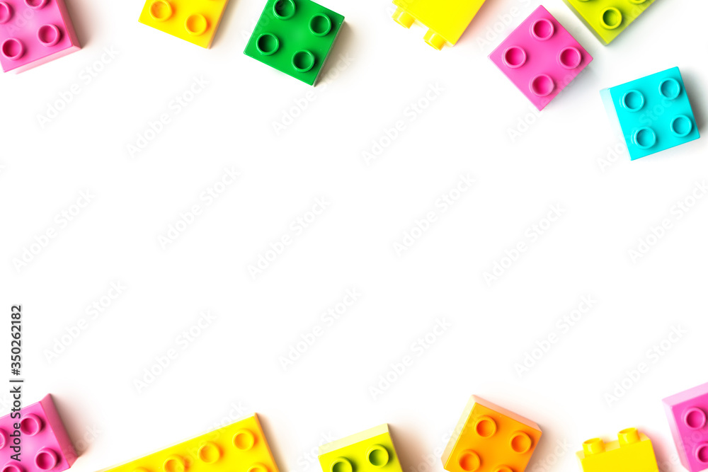 Lot of colorful rainbow toy bricks background. Educational toy for children Isolated on white background. Top view with copy space Lot of colorful rainbow toy bricks background. Educational toy for children Isolated on white background. Top view with copy space