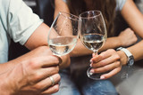 Two glasses of wine in the hands of a man and a woman.
