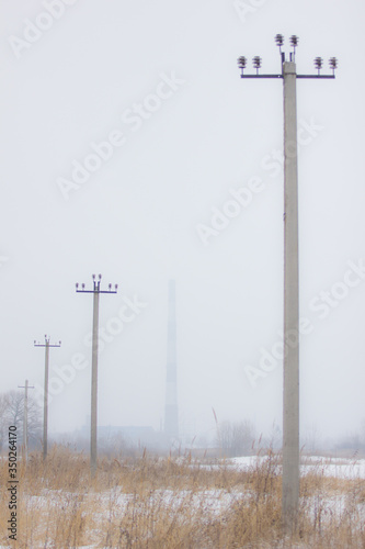 winter foggy field with road posts photo