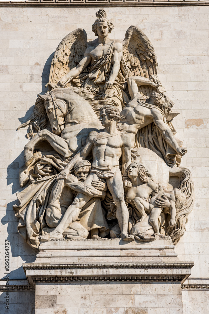Statue on the wall of the Arc de Triomphe at the Champs-Elysees Avenue in Paris,