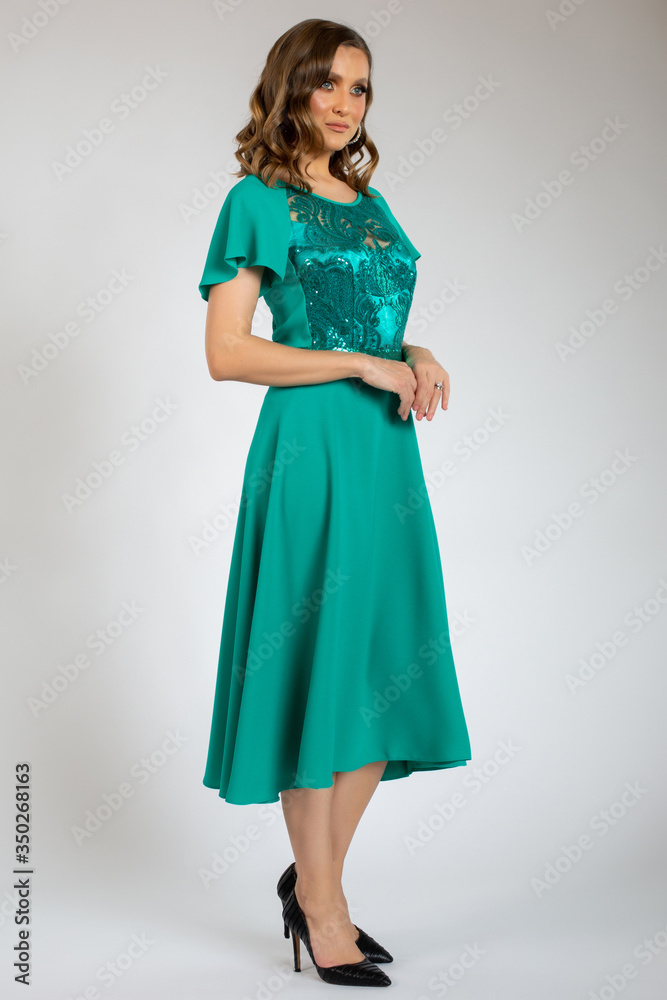 Fototapeta premium beautiful girl posing in green dress
